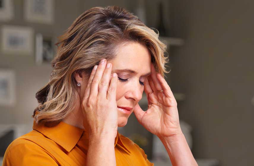 Woman having headache migraine | Toronto Hypnosis